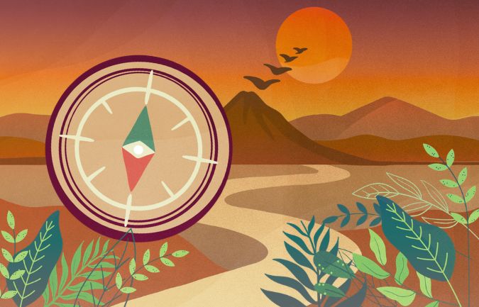 Compass points toward a horizon with mountains.